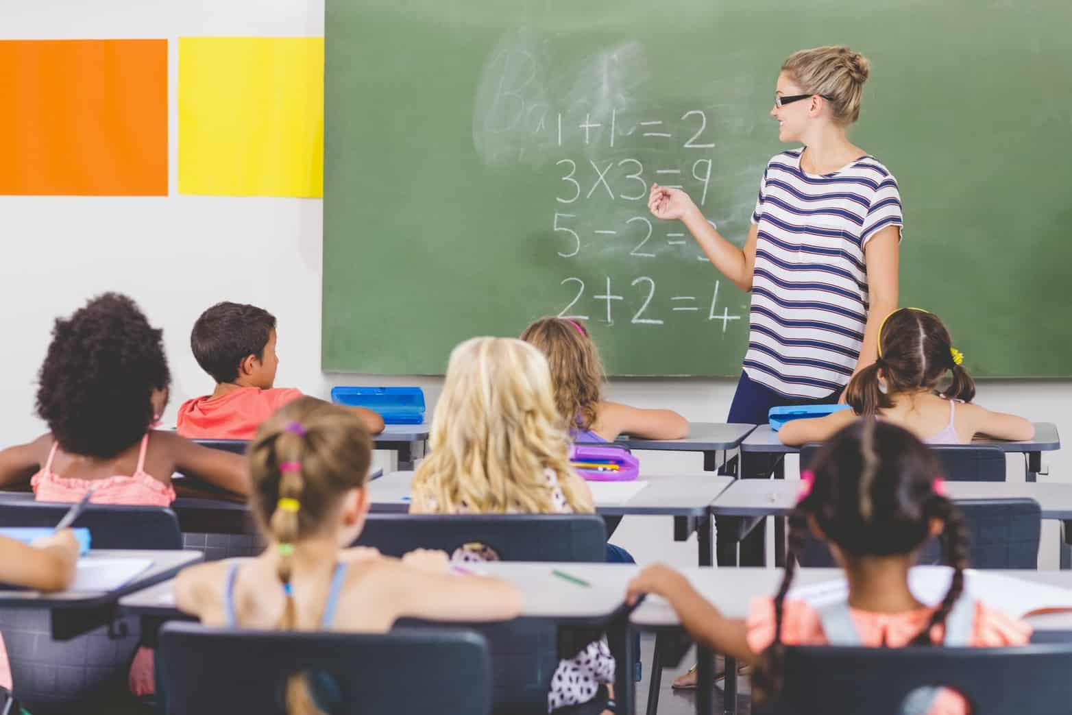 Teacher teaching mathematics to students in a classroom
